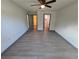 Bedroom featuring vinyl floors, ceiling fan, and a view into the ensuite bathroom at 262 Locust Rd, Ocala, FL 34472