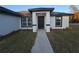 Front entry of a new home with landscaping at 262 Locust Rd, Ocala, FL 34472