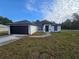 A cozy single-story home featuring a dark roof and a well manicured lawn at 262 Locust Rd, Ocala, FL 34472