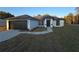 Newly built home with a two-car garage and landscaped yard at 262 Locust Rd, Ocala, FL 34472