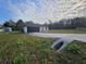 A view of the home featuring a two-car garage and concrete driveway at 262 Locust Rd, Ocala, FL 34472