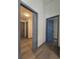 Hallway features laminate flooring and multiple grey doors that lead to other rooms at 262 Locust Rd, Ocala, FL 34472