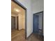 Hallway with wood floors, and gray doors with white walls in a modern color scheme at 262 Locust Rd, Ocala, FL 34472