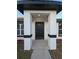 Modern house entrance with black front door and white columns at 262 Locust Rd, Ocala, FL 34472