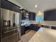 Modern kitchen with stainless steel appliances, white countertops, and dark cabinets at 262 Locust Rd, Ocala, FL 34472