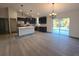 Modern kitchen with island and dining area with sliding glass doors at 262 Locust Rd, Ocala, FL 34472