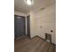 Laundry area with grey trim and wood-look flooring; hook-ups and shelving at 262 Locust Rd, Ocala, FL 34472