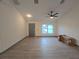 Bright living room featuring wood-look floors and ceiling fan at 262 Locust Rd, Ocala, FL 34472