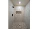 Modern shower with marble tile walls and pebble floor at 262 Locust Rd, Ocala, FL 34472