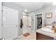 Modern bathroom with double sinks, walk-in shower, and linen closet at 2936 Ne 43Rd Rd, Ocala, FL 34470