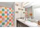 Clean bathroom with double sinks and colorful shower curtain at 2936 Ne 43Rd Rd, Ocala, FL 34470