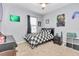 Checkered bedspread and gaming decor in this well-lit bedroom at 2936 Ne 43Rd Rd, Ocala, FL 34470