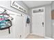 White-paneled entryway with hooks for bags and a decorative sign at 2936 Ne 43Rd Rd, Ocala, FL 34470