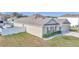 One-story house with light beige siding, brown shutters, and a two-car garage at 2936 Ne 43Rd Rd, Ocala, FL 34470