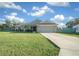 Single-story home with gray siding, attached garage, and a well-manicured lawn at 38 Spring Trce, Ocala, FL 34472