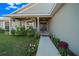 Covered front porch with walkway, potted plants, and a charming entrance at 38 Spring Trce, Ocala, FL 34472