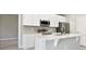 Modern white kitchen with stainless steel appliances and island at 3824 Sw 166Th Place Rd, Ocala, FL 34473