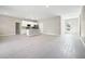 Open living space with kitchen and island, grey tile floors at 3824 Sw 166Th Place Rd, Ocala, FL 34473