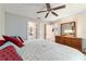 Bedroom with king bed, ensuite bathroom access, and ceiling fan at 3899 Se 80Th St, Ocala, FL 34480