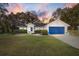 Charming single-story home with a blue garage door and well-manicured lawn at 3899 Se 80Th St, Ocala, FL 34480