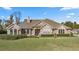 Single-story home with stone and shingle accents, showcasing a manicured lawn at 4020 Se 9Th Ave, Ocala, FL 34480