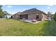 Home exterior showcasing backyard patio and grass at 4020 Se 9Th Ave, Ocala, FL 34480