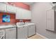 Bright laundry room featuring ample cabinet space, a utility sink, and modern appliances at 4020 Se 9Th Ave, Ocala, FL 34480