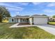 Newly built home with green siding, white garage door, and a landscaped yard at 5 Locust Trak, Ocala, FL 34472