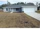 Newly constructed home with gray siding, white garage door, and a small front yard at 5 Locust Trak, Ocala, FL 34472