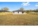 A fenced backyard with a view of the house and a clear blue sky at 5200 Nw 54Th Pl, Ocala, FL 34482