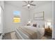 Bright bedroom features a ceiling fan, nice picture window and neutral decor at 5200 Nw 54Th Pl, Ocala, FL 34482