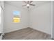 Empty bedroom with a ceiling fan, wood floors, and a window at 5200 Nw 54Th Pl, Ocala, FL 34482