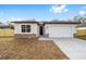 Charming single-story home with a stone facade, a two-car garage, and a well-manicured lawn at 5200 Nw 54Th Pl, Ocala, FL 34482