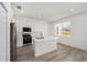 Modern kitchen featuring white cabinetry, stainless steel appliances, and an island with a sink at 5200 Nw 54Th Pl, Ocala, FL 34482