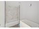 Bathroom with a white bathtub and marble-look tile at 55 Locust Loop Cir, Ocala, FL 34472