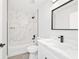 Elegant bathroom with tiled shower, white vanity, and black accents creating a sleek design at 55 Locust Loop Cir, Ocala, FL 34472