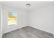 Bright bedroom with large window and grey vinyl flooring at 55 Locust Loop Cir, Ocala, FL 34472