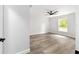 Bright bedroom with ceiling fan, neutral walls, and wood-look flooring at 55 Locust Loop Cir, Ocala, FL 34472