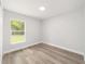 Inviting bedroom with wood-look floors and ample natural light from the window at 55 Locust Loop Cir, Ocala, FL 34472