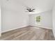 Well-lit bedroom with ceiling fan, neutral walls, and wood-look flooring at 55 Locust Loop Cir, Ocala, FL 34472