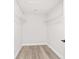 Walk-in closet with white wire shelving and wood-look flooring provides ample storage at 55 Locust Loop Cir, Ocala, FL 34472
