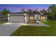 Beautiful single-story home featuring a two-car garage, manicured lawn, and a welcoming entryway at twilight at 55 Locust Loop Cir, Ocala, FL 34472