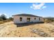 Rear view of house with patio and yard at 55 Locust Loop Cir, Ocala, FL 34472