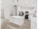 Modern kitchen with white cabinets, stainless steel appliances, and a center island at 55 Locust Loop Cir, Ocala, FL 34472