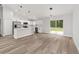 Modern kitchen with white cabinets, stainless steel appliances, and a center island at 55 Locust Loop Cir, Ocala, FL 34472