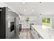 Well-lit kitchen with island, stainless steel appliances, and stylish countertops at 55 Locust Loop Cir, Ocala, FL 34472