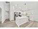 Modern kitchen with white cabinets, stainless steel appliances, and center island at 55 Locust Loop Cir, Ocala, FL 34472