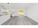 Modern kitchen with white shaker cabinets and gray vinyl flooring at 55 Locust Loop Cir, Ocala, FL 34472