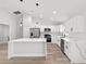Bright kitchen with white cabinets, stainless steel appliances, and large island at 55 Locust Loop Cir, Ocala, FL 34472