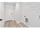 Bright laundry room with shelving, washer/dryer hookups, and neutral-toned flooring at 55 Locust Loop Cir, Ocala, FL 34472